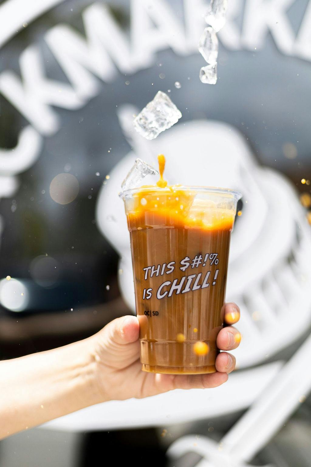 a hand holding a glass cup